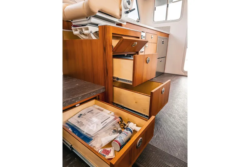 Slide: The Image of Open wooden drawers in a Lindell 46 boat interior, showcasing storage space, 2024 model. - 47