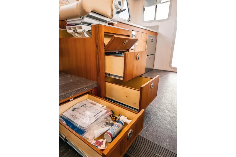 Slide: The Image of Open wooden drawers in a 2024 Lindell 46 boat interior, showcasing storage space. - 48
