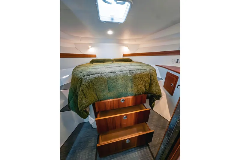 Slide: The Image of Luxurious cabin interior of 2024 Lindell 46 yacht with cozy bed and wooden storage drawers. - 53