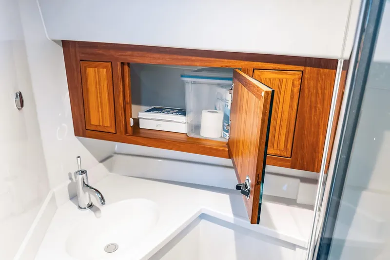 Slide: The Image of Modern bathroom cabinet in 2024 Lindell 46 yacht, featuring wood finish and sleek sink design. - 56
