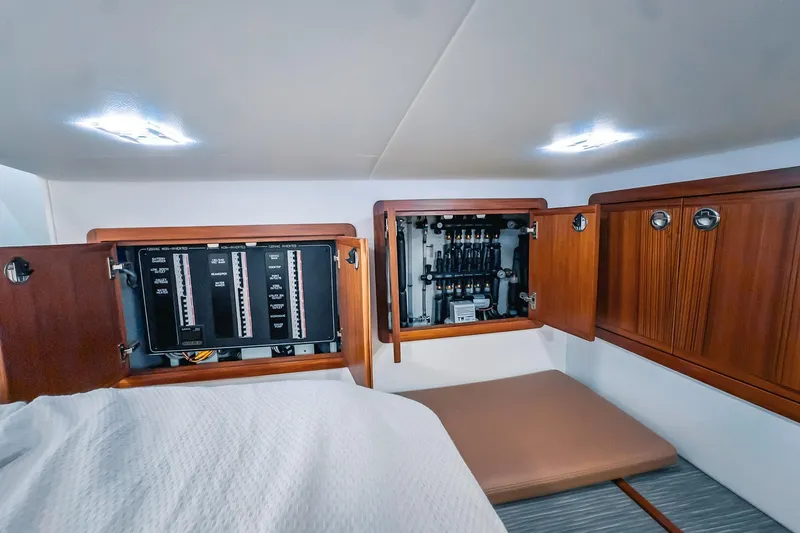 Slide: The Image of Electrical panel and storage cabinets inside a 2024 Lindell 46 boat interior. - 59