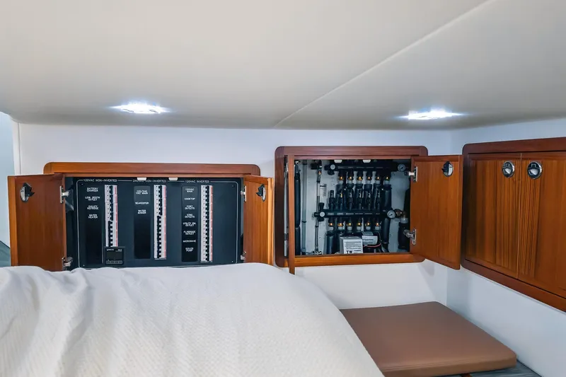 Slide: The Image of Electrical panel and storage cabinets inside a 2024 Lindell 46 boat interior. - 60