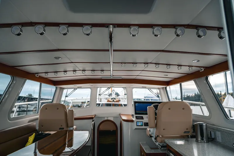 Slide: The Image of Interior of 2024 Lindell 46 yacht, featuring modern helm and luxurious seating. - 62