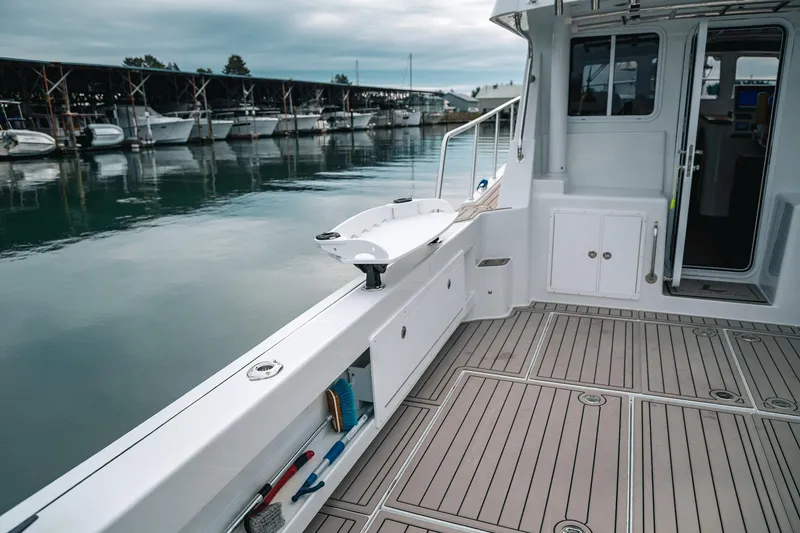 Slide: The Image of 2024 Lindell 46 boat deck with modern design, docked at marina. - 64