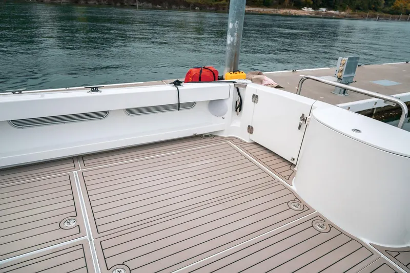 Slide: The Image of 2024 Lindell 46 boat deck with sleek design, docked by calm waters. - 67