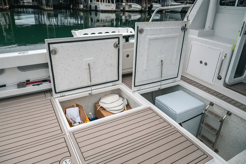 Slide: The Image of 2024 Lindell 46 boat storage compartments open, revealing organized interior space. - 75