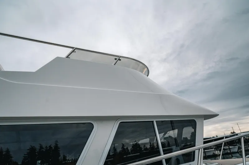 Slide: The Image of 2024 Lindell 46 yacht exterior with sleek design against cloudy sky. - 85