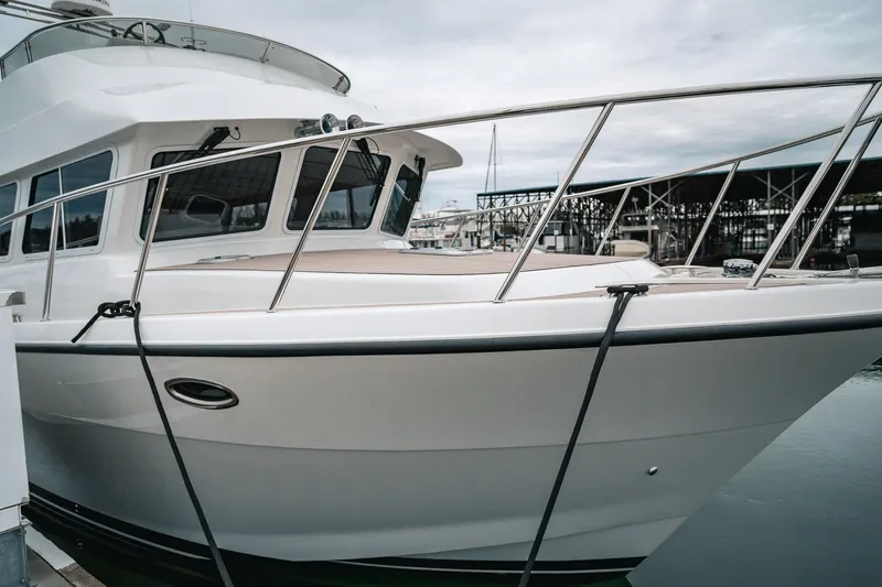 Slide: The Image of 2024 Lindell 46 yacht docked at marina, showcasing sleek design and modern features. - 86