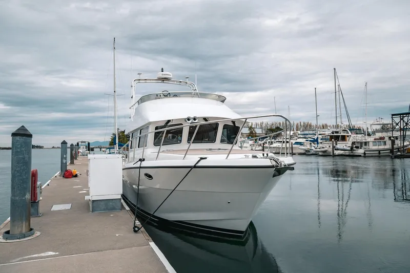 Slide: The Image of 2024 Lindell 46 yacht docked at marina under cloudy sky. - 90
