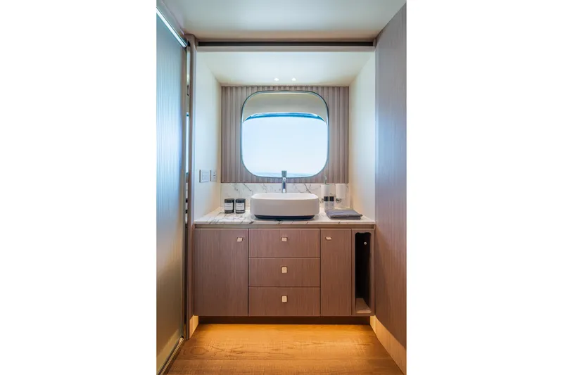 Slide: The Image of Luxurious bathroom interior on 2026 Absolute 62' Navetta yacht, featuring modern sink and cabinetry. - 25