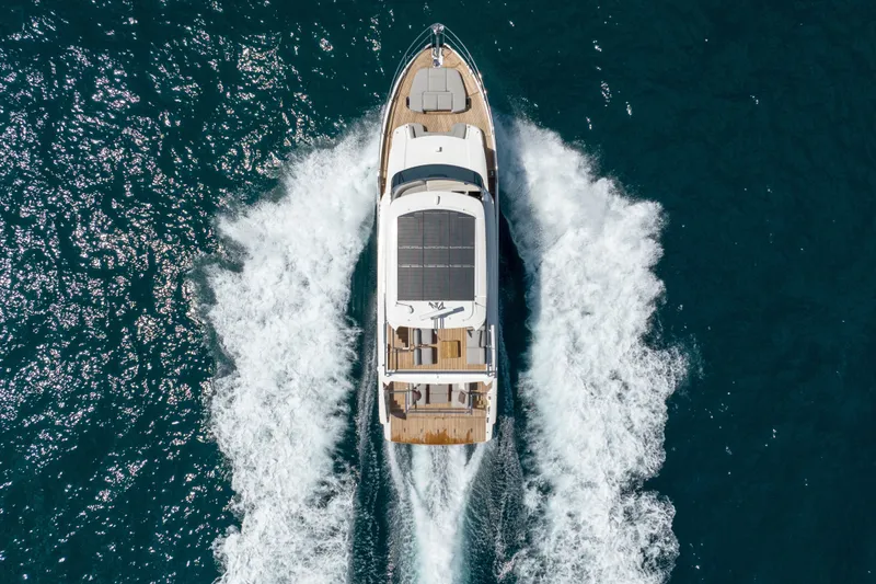 Slide: The Image of Aerial view of 2027 Absolute Navetta 62 yacht cruising on open sea. - 16