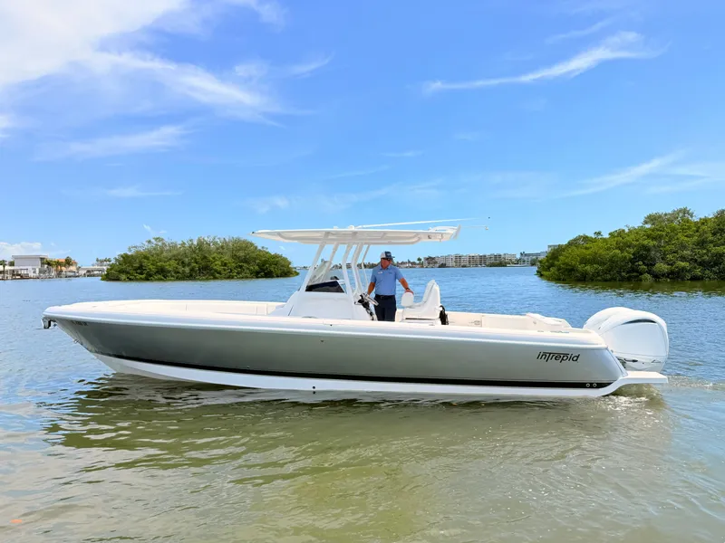 Slide: The Image of 2020 Intrepid 327CC boat on calm water with blue sky. - 13