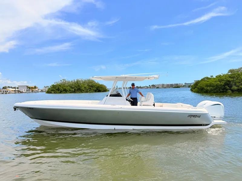 Slide: The Image of 2020 Intrepid 327CC boat on calm water with blue sky. - 14