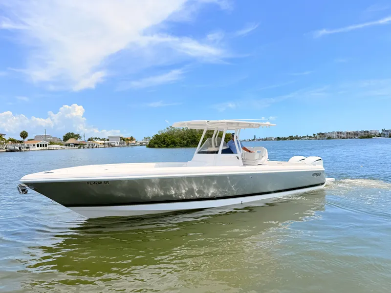 Slide: The Image of 2020 Intrepid 327CC boat on calm water under clear sky. - 17