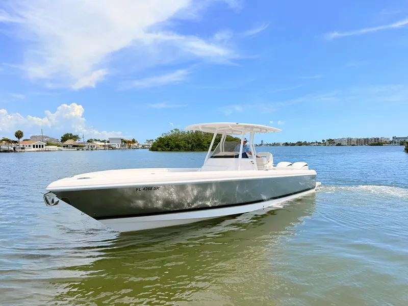 Slide: The Image of 2020 Intrepid 327CC boat on calm water under clear sky. - 18