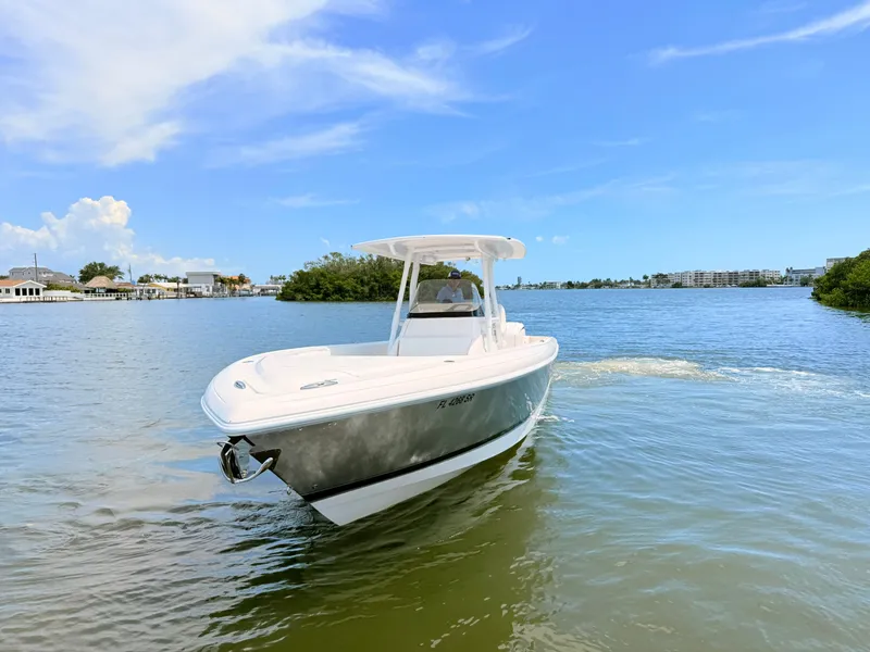 Slide: The Image of 2020 Intrepid 327CC boat on calm water under sunny skies. - 19