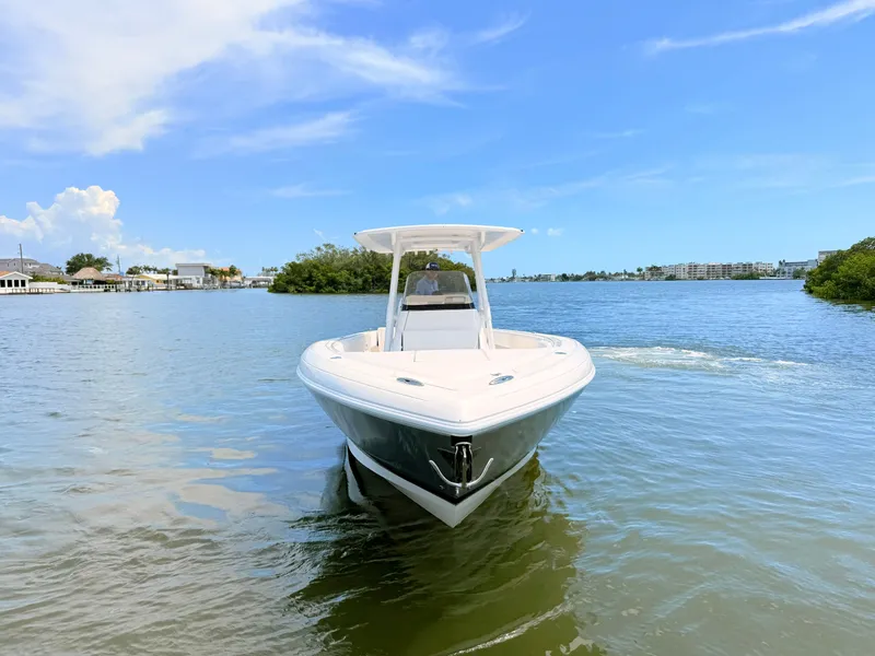 Slide: The Image of 2020 Intrepid 327CC boat on calm water under clear sky. - 20