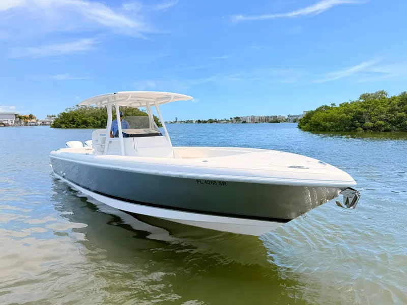 Slide: The Image of 2020 Intrepid 327CC boat on calm water. - 22