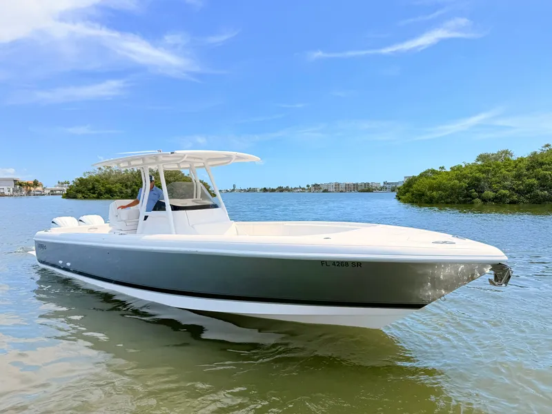 Slide: The Image of 2020 Intrepid 327CC boat on calm water under clear sky. - 23