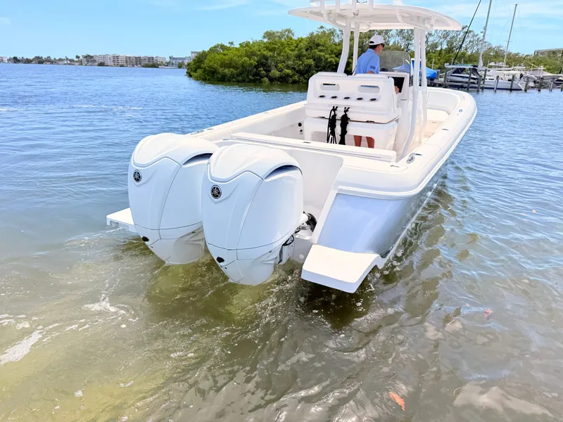 Slide: The Image of Intrepid 327CC boat 2020 on calm water with twin outboard engines. - 25
