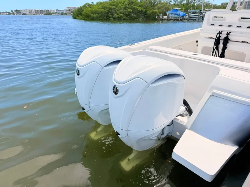 Slide: The Image of Intrepid 327CC 2020 with twin outboard engines on calm water. - 27