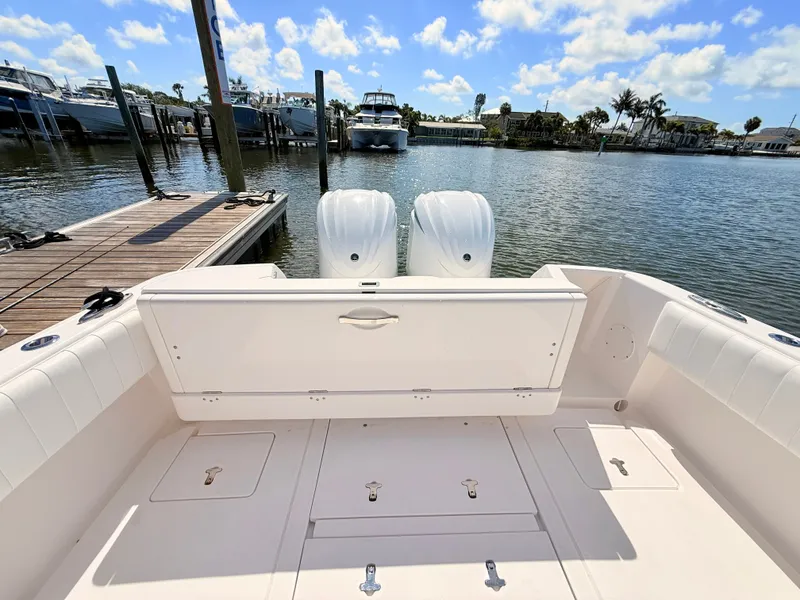 Slide: The Image of Intrepid 327CC 2020 boat at dock with twin outboard engines. - 29