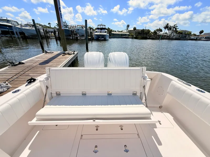 Slide: The Image of Intrepid 327CC 2020 boat at dock with seating bench. - 30