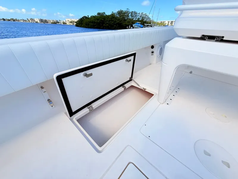 Slide: The Image of Intrepid 327CC 2020 with open storage compartment by the water. - 33