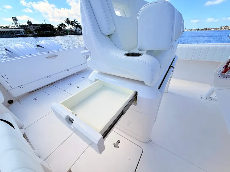 Slide: The Image of Intrepid 327CC 2020 with open seat drawer on the water. - 48