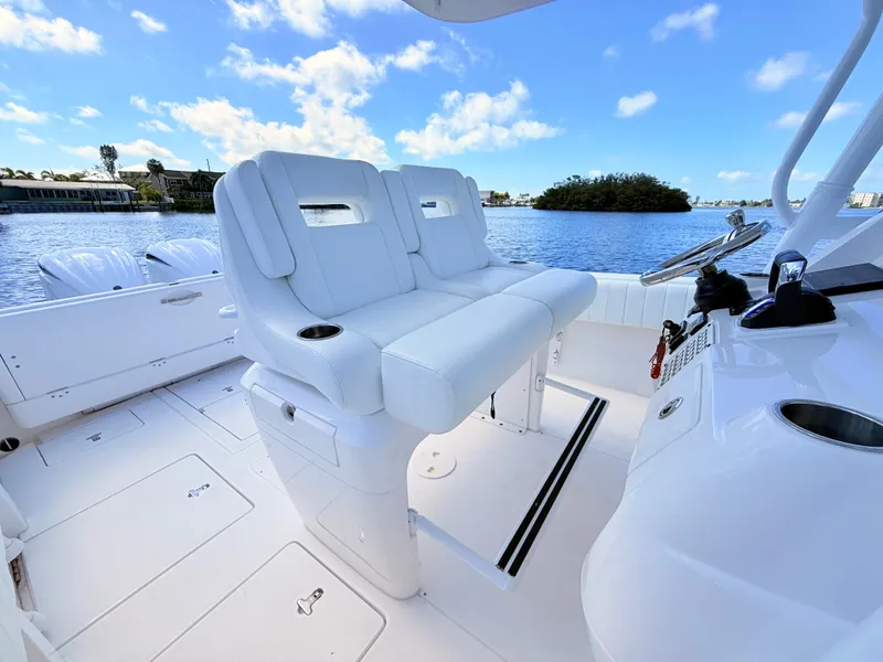 Slide: The Image of Intrepid 327CC 2020 boat with luxurious cockpit and white seating area. - 49