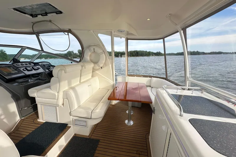 Slide: The Image of 2008 Cruisers Yachts 415 Express Motoryacht interior with elegant seating and scenic water view. - 12