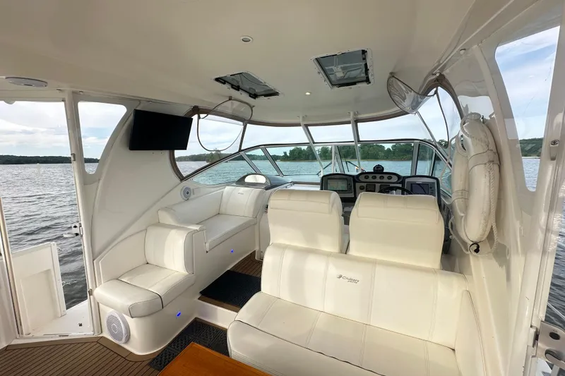 Slide: The Image of 2008 Cruisers Yachts 415 Express Motoryacht interior with plush seating and scenic water view. - 13