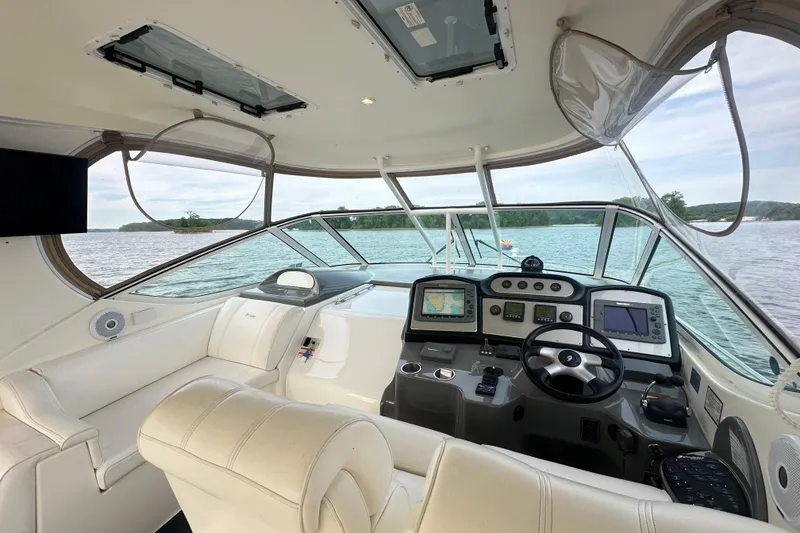 Slide: The Image of 2008 Cruisers Yachts 415 Express Motoryacht helm with navigation screens and steering wheel. - 16