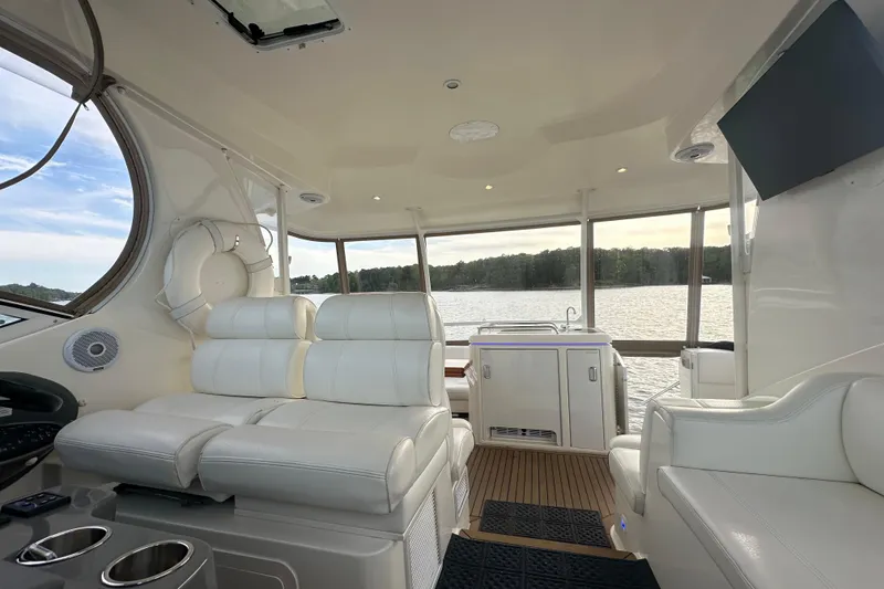 Slide: The Image of Luxurious interior of 2008 Cruisers Yachts 415 Express Motoryacht with white seating and scenic lake view. - 20
