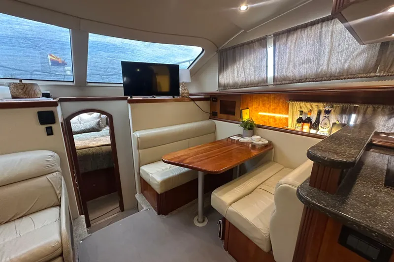 Slide: The Image of Luxurious interior of 2008 Cruisers Yachts 415 Express Motoryacht with dining area and TV. - 24