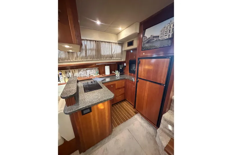 Slide: The Image of Luxurious kitchen interior of 2008 Cruisers Yachts 415 Express Motoryacht with wood cabinetry. - 28