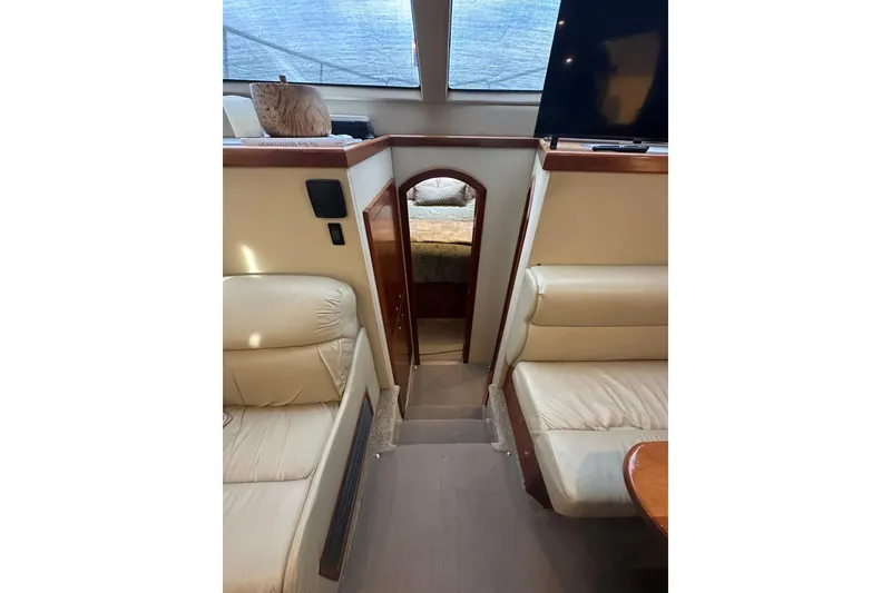 Slide: The Image of Interior of 2008 Cruisers Yachts 415 Express Motoryacht with beige seating and wooden accents. - 36
