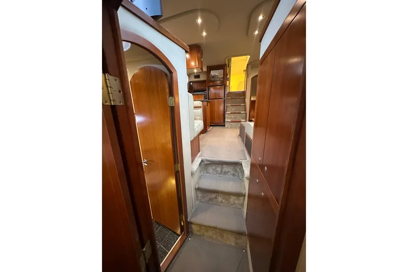 Slide: The Image of Interior view of 2008 Cruisers Yachts 415 Express Motoryacht with wooden cabinetry and carpeted stairs. - 37