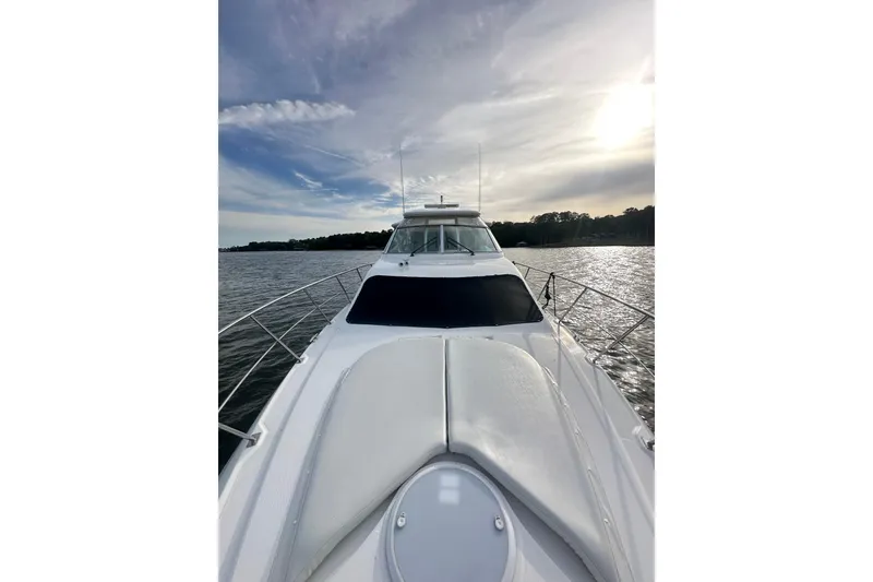 Slide: The Image of 2008 Cruisers Yachts 415 Express Motoryacht on serene water under a cloudy sky. - 6