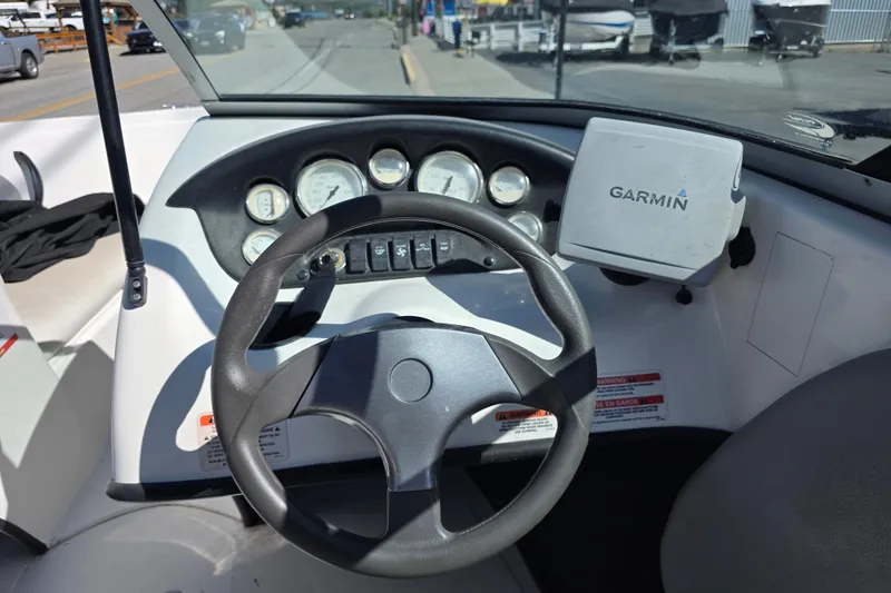 Slide: The Image of Steering wheel and dashboard of 2014 Reinell 207 LS boat with Garmin GPS. - 11