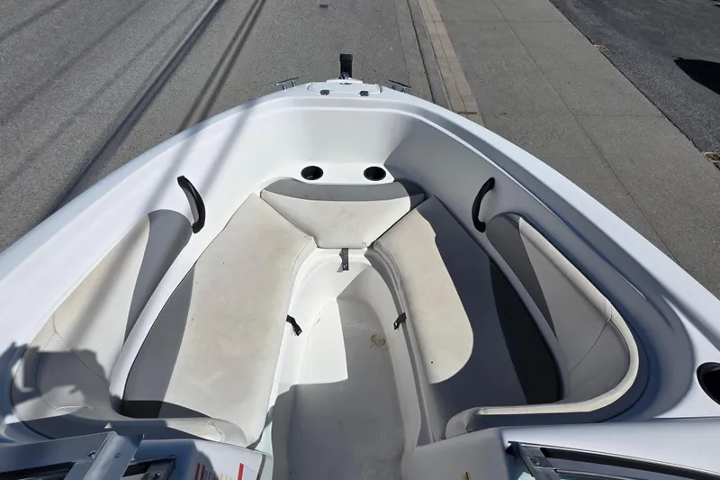 Slide: The Image of 2014 Reinell 207 LS boat interior with white seating and sleek design. - 13