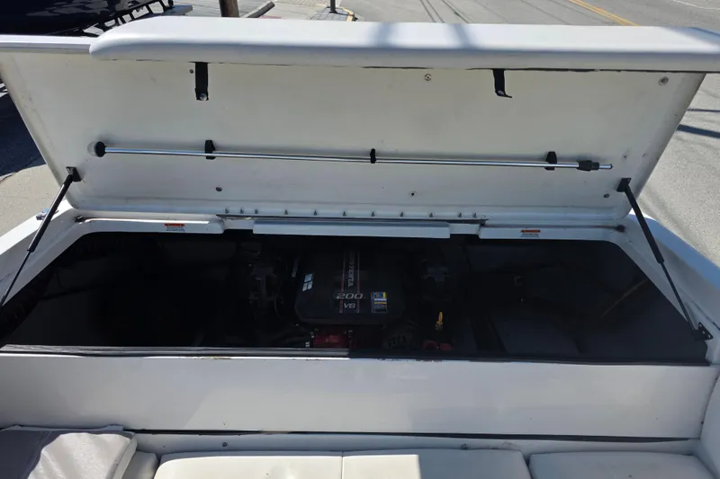 Slide: The Image of Open engine compartment of a 2014 Reinell 207 LS boat, showcasing the V6 engine. - 6