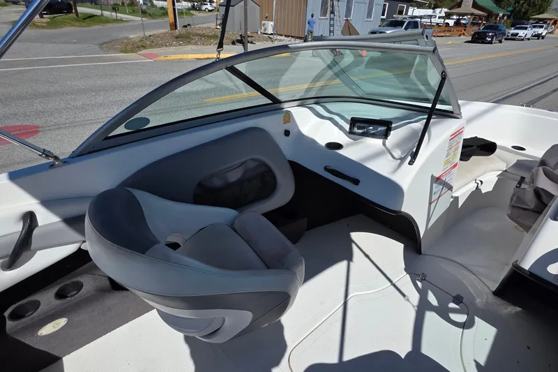 Slide: The Image of Interior of a 2014 Reinell 207 LS boat, featuring seating and dashboard controls. - 9