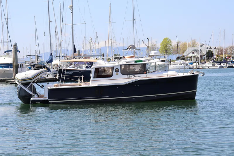 The Image of 2023 Ranger Tugs R-27 boat named "Blue Dream" docked in a marina. - 0