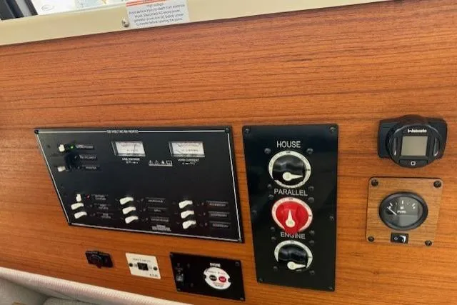 Slide: The Image of Control panel of 2023 Ranger Tugs R-27 boat with switches and gauges. - 12