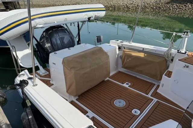 Slide: The Image of 2023 Ranger Tugs R-27 boat deck with wood finish and covered seating. - 19