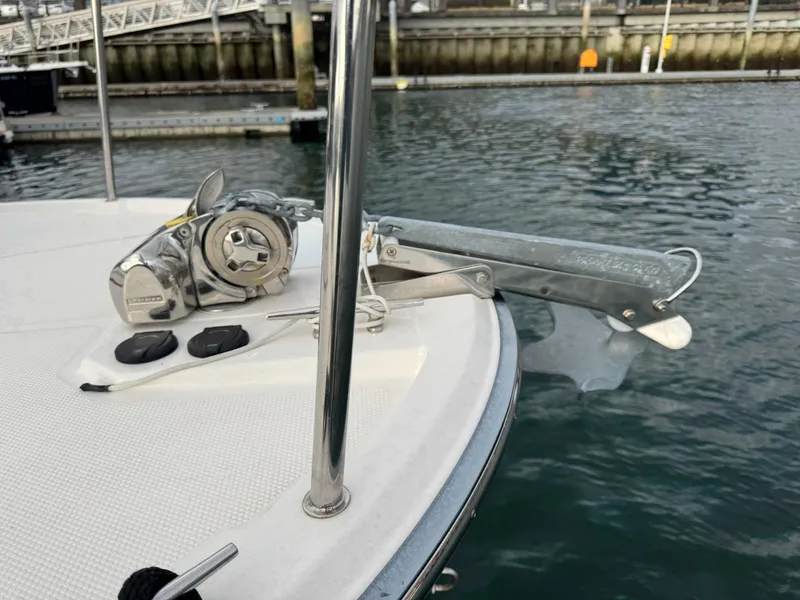 Slide: The Image of 2022 Ranger Tugs R-27 boat anchor system at dockside, featuring a winch and anchor roller. - 26