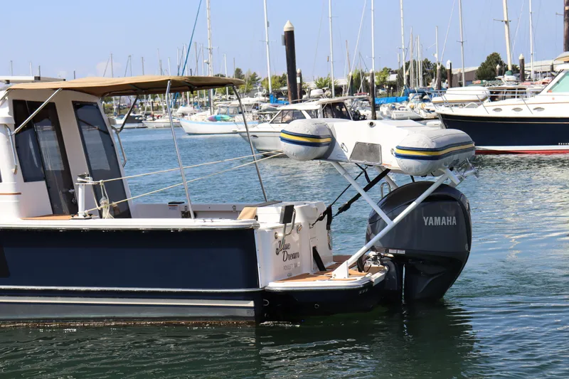 Slide: The Image of 2023 Ranger Tugs R-27 boat with Yamaha motor in marina setting. - 5