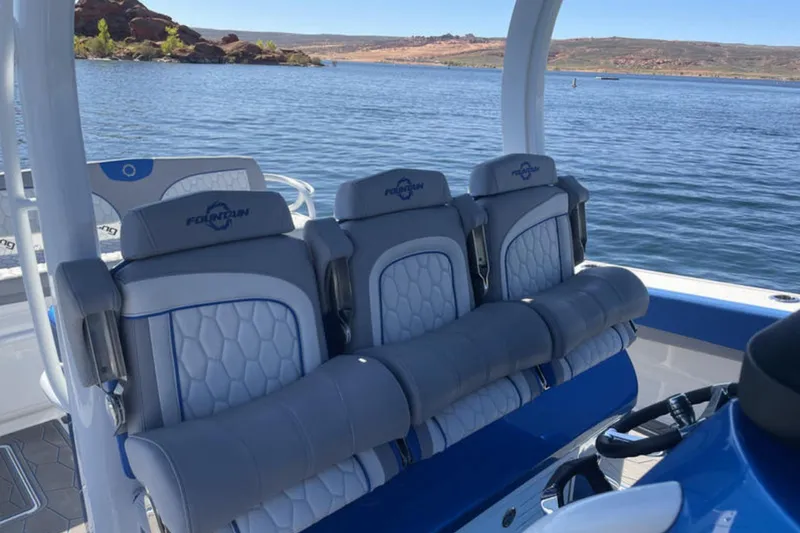 Slide: The Image of 2023 Fountain 43 NX boat interior with luxurious seating on a serene lake. - 10