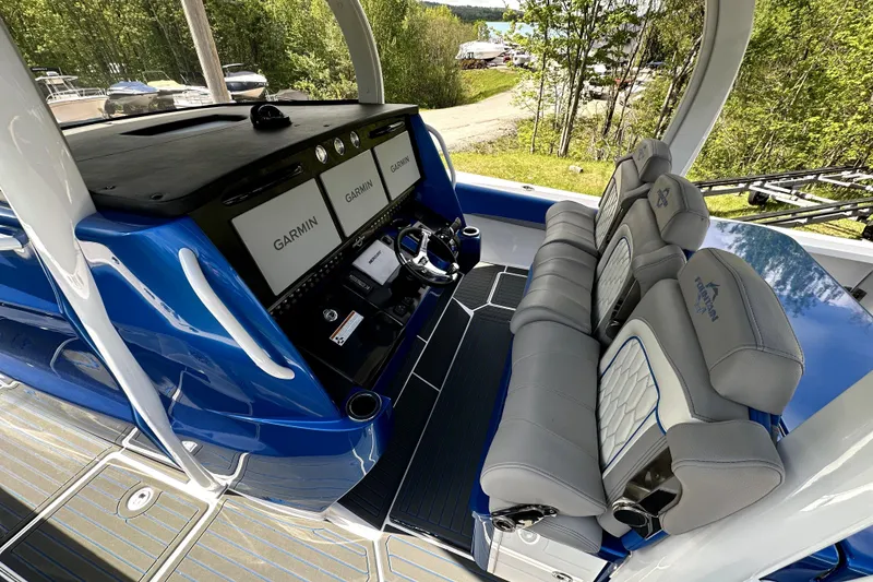 Slide: The Image of 2023 Fountain 43 NX boat cockpit with Garmin displays and luxurious seating. - 13
